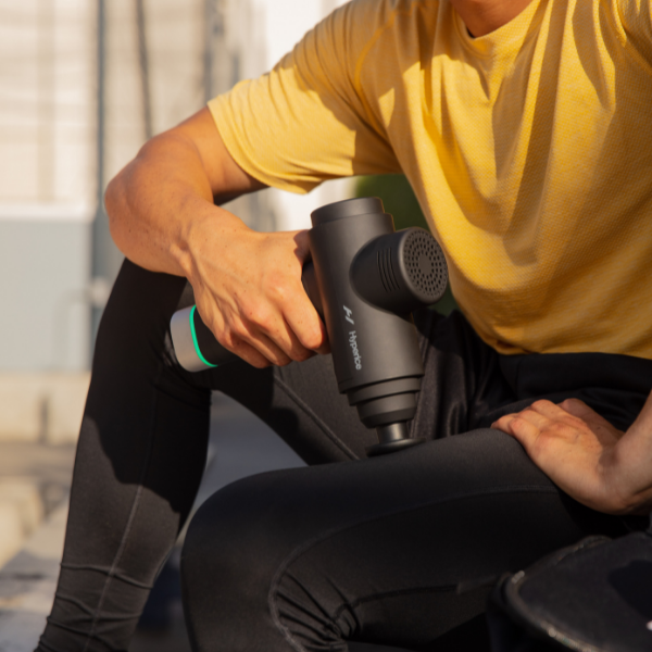 Man using a Hyperice Hypervolt 2 Pro percussion massage gun